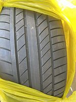 Close-up of the tread on one of the tires showing tread depth and pattern.
