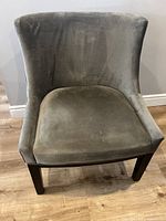 Front angled view of the grey fabric accent chair showing the full seat and backrest.