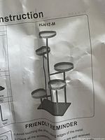 Installation instruction sheet showing the assembled form of the 5-tier plant stand with circular platforms.