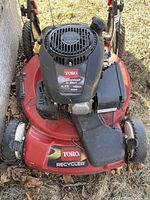 Close-up front view of Toro Recycler gasoline-powered lawn mower showing engine, model detail, and cutting deck