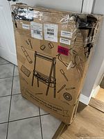 Photo of a damaged but unopened cardboard box with printed illustration of the double-sided kids art easel, showing the overall design and art tool accessory illustrations.
