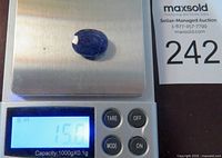Blue faceted sapphire gemstone placed on a digital scale showing weight of 15.0 carats, confirming the seller's stated carat weight.
