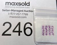 Bag of 24 small faceted round purple amethyst stones arranged in rows on a white background beside a number card.
