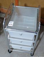 Front view of the 3-level storage container showing the chrome frame and translucent drawers.