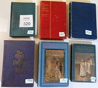 Top-down view of six antique books with visible publication years 1893, 1901, 1907, 1911, 1914, 1916. Colors vary with red, blue, green, and purple covers.