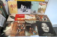 Overhead shot of eleven vinyl LP album covers arranged in two rows