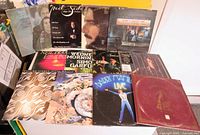 Photo showing 12 vintage vinyl records with various artistic covers and artists including Neil Sedaka, Simon & Garfunkel, The Moody Blues, and more.