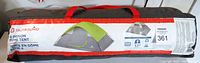 Photo of the packed tent bag showing the brand Outbound and product info tag.