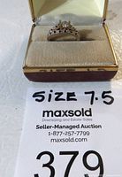 Rings displayed in original box with size 7.5 noted on tag.