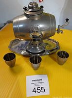 Full lot shot on yellow table background showing barrel decanter, tray and three cups