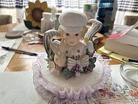 Front view of David figurine on table with background items visible