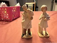 Front view of both doctor and nurse porcelain figurines on a table