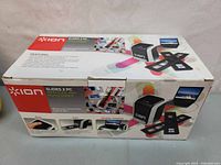 Photo of the Ion Slides 2 PC scanner packaged in the original box highlighting features and images of the device and its usage.