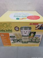 Photo of Magic Bullet Baby Bullet box showing the food maker blender and multiple components with graphic display of the 20 piece set.
