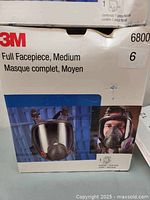 Box showing 3M branding, model 6800, medium facepiece size noted on box