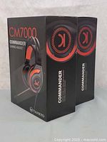 Front and side view of two sealed retail boxes of VANKYO CM7000 Commander Pro gaming headsets showing branding and product image.