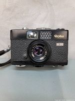 Front view of black Rollei 35B camera showing retractable 40mm f3.5 Triotar lens and Rollei branding.