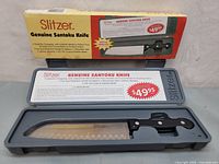 Box packaging showing Slitzer Genuine Santoku Knife branding and product details with price $49.95
