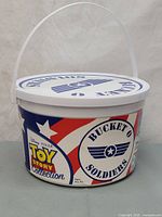 Full view of white bucket with Toy Story Signature Collection branding and Bucket O Soldiers logo.