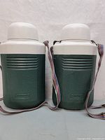 Front view of two Coleman 1-liter drink coolers side by side with adjustable shoulder straps.