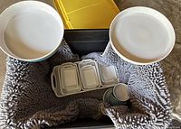 Top-down view of the set showing two round serving dishes, rectangular trays, small plates, and a small bowl all placed on a gray textured mat.