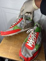 Side view of Nike Dbreak-Type shoe showing grey, green, orange fabric and recycled sole material