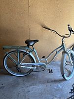 Full side view of vintage Schwinn Petite Ballerina bicycle showing frame, saddle, rear rack, tires.