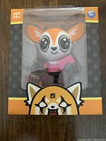 Front view of sealed Retsuko figurine in original orange and gray packaging with character logo and Ages 14+ indication.