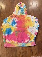 Back view of Blue Notes tie dye hoodie in XL size, showing vibrant blue, yellow, pink tie dye pattern.