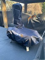 Pizzello pellet pizza oven covered with protective black cover and chimney cover