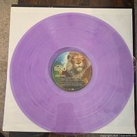 Close-up of one translucent purple vinyl record with Sing 2 label in center