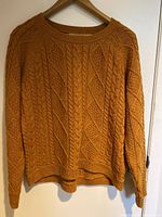 Front view of mustard color ladies medium vintage cable knit sweater by Orvis with cable and diamond knit pattern