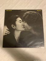 Front cover of Double Fantasy vinyl record showing John Lennon and Yoko Ono kissing.
