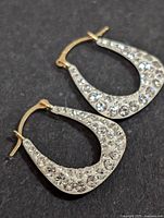 Side view showing rhinestone front of 10KT gold earrings
