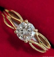 Top view showing round brilliant diamond in four-prong setting on split shank