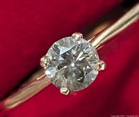 Close-up of round brilliant diamond and prong setting
