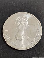 Obverse of the 1973 Canadian silver 5 dollar coin showing Queen Elizabeth II's profile with inscriptions and maple leaf.