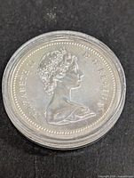 Obverse side of silver Canadian dollar coin with portrait of Queen Elizabeth II and inscription 'ELIZABETH II D.G. REGINA'
