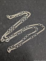 Full view of the 16-inch silver necklace showing the chain links and overall design.