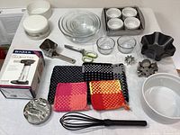 Overview of all baking accessories including torch, ramekins, pans, scissors, cookie cutters, pot holders, glass bowls, whisk