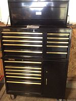 Full front view of assembled tool cabinet showing top chest, lower cart, locks and caster wheels.