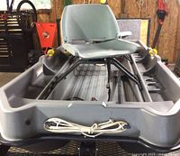 Front view of grey fiberglass hull with bow rope and single swivel seat on pedestal