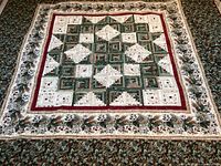Overall view of quilt laid flat showing full front pattern and borders