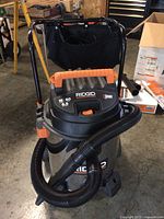 Front view of assembled vacuum with hose wrapped around