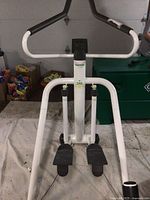 Front view of Tunturi Tri-Stepper 500 with black pedals and white frame, showing handlebars and footrests.