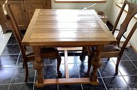 Table with both leaves closed and two chairs inserted under ends