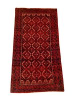 Photo of a rectangular Baluchi small backrest rug featuring red and brown geometric diamond and square motifs, woven from natural sheep wool.