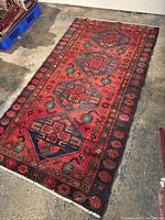 Full view of the rectangular Zanjan tribal rug laid on concrete floor, showing overall design and condition.