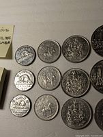 Close-up view showing 9 coins including nickels and some of the dollar and 50 cent coins