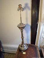 Full view of the antique Victorian style lamp showing metal base, twisted stem, dual bulb holders, and ribbed glass pumpkin insert